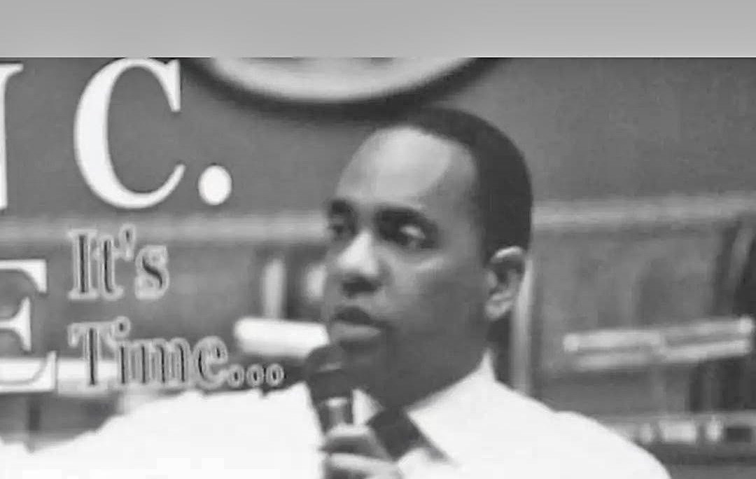 Black-and-white photo of Ronald C. Rice speaking into a microphone