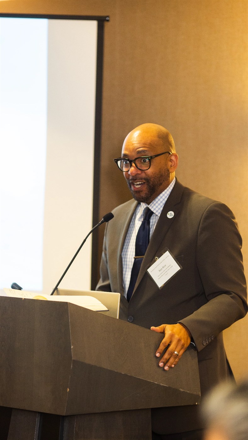 Ronald C. Rice speaking at a lectern at the 9th Annual Charter School Leaders of Color Day on the Hill advocacy training