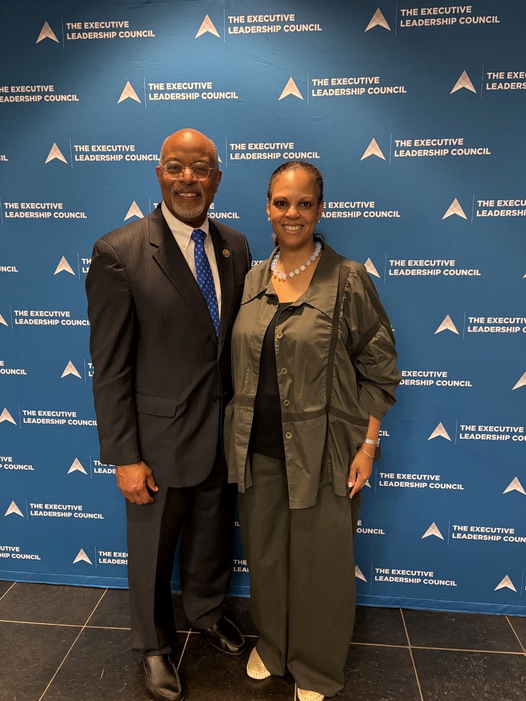 Libi Sprow Rice with a colleague in front of The Executive Leadership Council backdrop